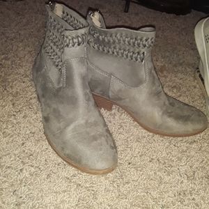 Greyish zip up ankle boots.